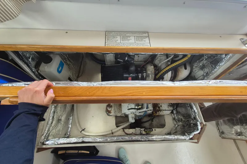 Slide: The Image of Engine compartment of a 1999 Nauset 33 Bridge Deck boat, showing mechanical components. - 33