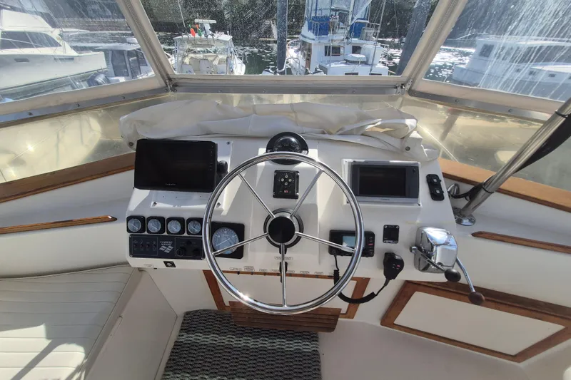 Slide: The Image of Helm of 1999 Nauset 33 Bridge Deck with steering wheel and navigation equipment. - 36