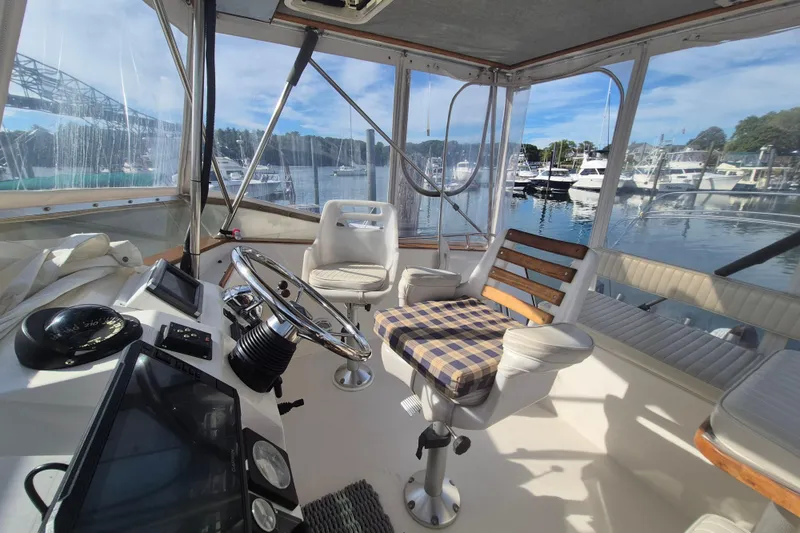 Slide: The Image of Interior view of 1999 Nauset 33 Bridge Deck boat with helm and seating. - 37