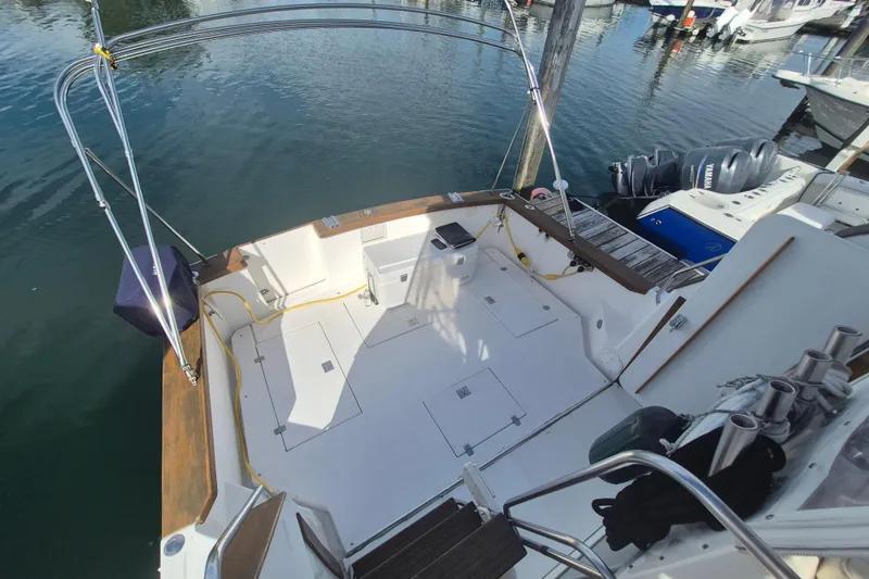 Slide: The Image of 1999 Nauset 33 Bridge Deck boat docked, featuring spacious deck and stainless steel railings. - 39