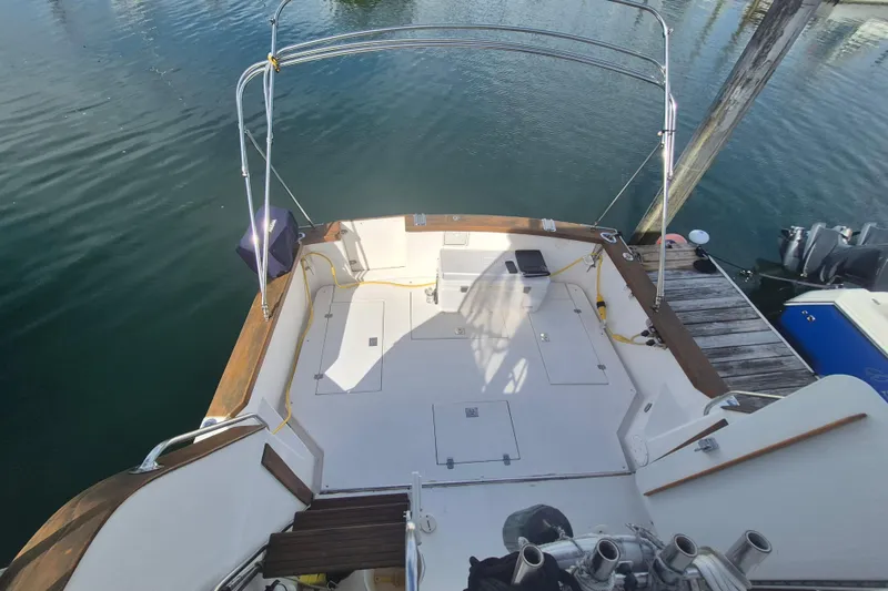 Slide: The Image of 1999 Nauset 33 Bridge Deck boat with spacious deck and dockside view. - 40