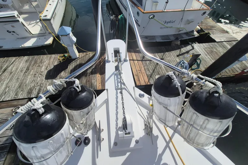 Slide: The Image of Bow view of 1999 Nauset 33 Bridge Deck boat docked at marina. - 45