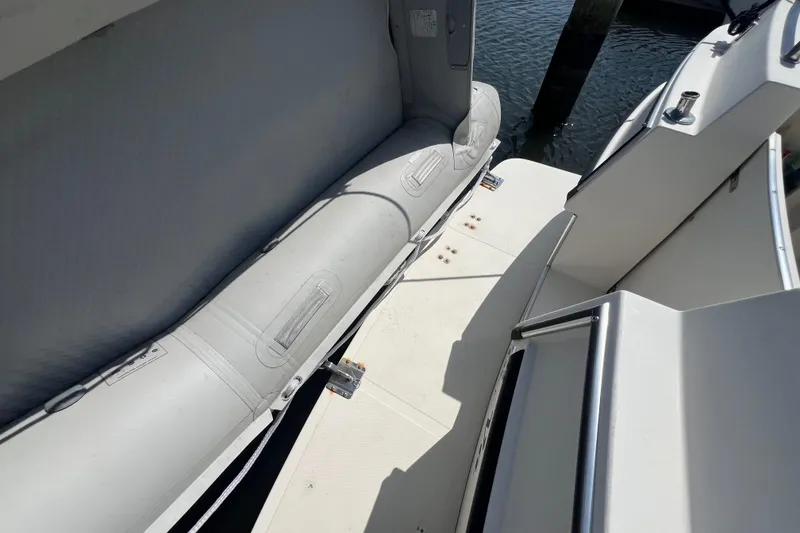 Slide: The Image of 2001 Camano 31 Troll boat deck with seating, docked by water. - 10