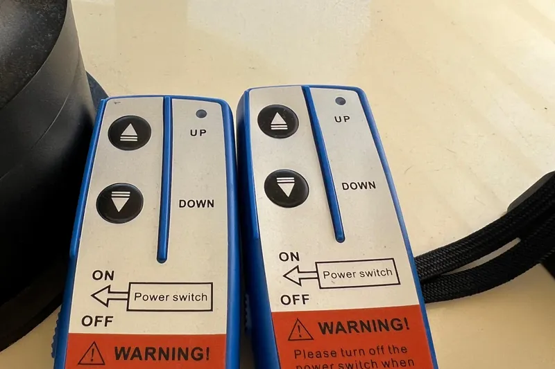 Slide: The Image of Remote controls with up and down buttons for Camano 31 Troll, 2001 model. - 13