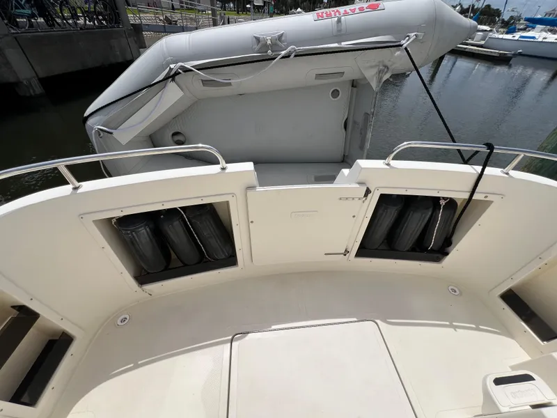 Slide: The Image of 2001 Camano 31 Troll boat deck with inflatable dinghy, docked at marina. - 16