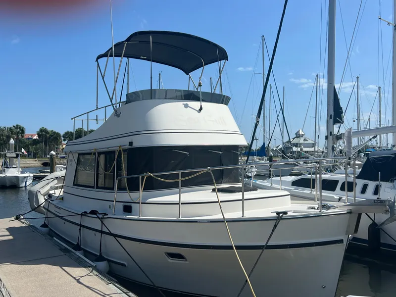 Slide: The Image of 2001 Camano 31 Troll boat docked at marina under clear blue sky. - 2