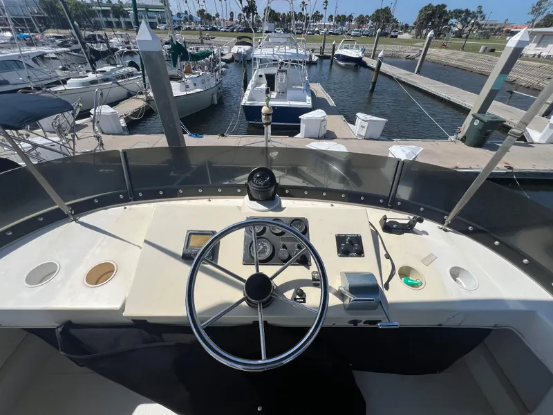 Slide: The Image of 2001 Camano 31 Troll boat helm with steering wheel and controls at marina. - 20