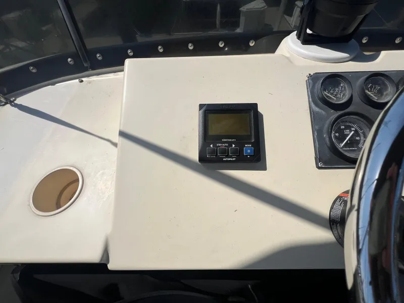 Slide: The Image of Control panel of a 2001 Camano 31 Troll boat with gauges and a display. - 23