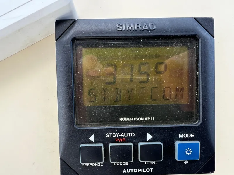 Slide: The Image of Simrad autopilot display on 2001 Camano 31 Troll boat, showing heading and mode settings. - 24