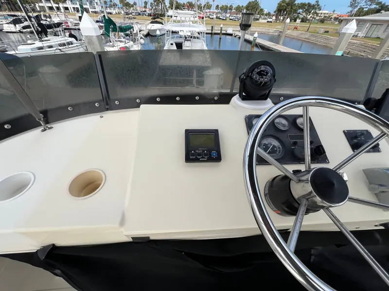 Slide: The Image of 2001 Camano 31 Troll boat helm with steering wheel and navigation instruments. - 25