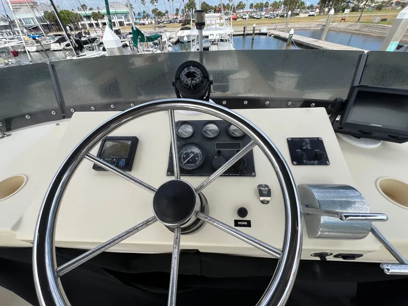 Slide: The Image of Helm of 2001 Camano 31 Troll boat with steering wheel and navigation instruments. - 26