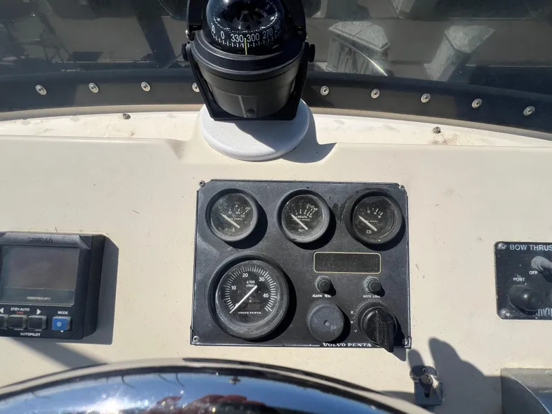 Slide: The Image of Control panel of a 2001 Camano 31 Troll boat with gauges and compass. - 27