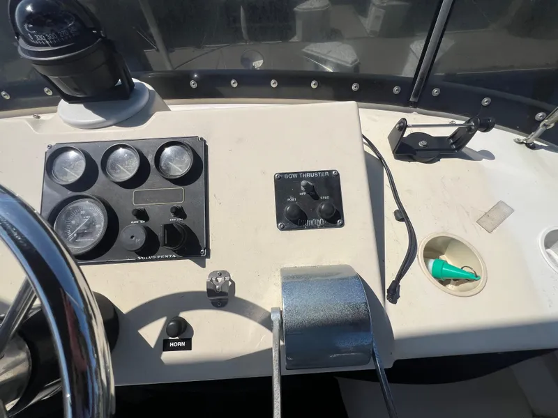 Slide: The Image of Control panel of a 2001 Camano 31 Troll boat with gauges and steering wheel. - 28