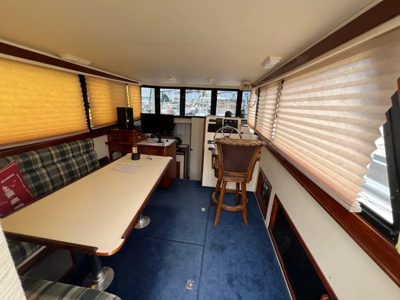 Slide: The Image of Interior of 2001 Camano 31 Troll boat with seating, table, and helm station. - 31