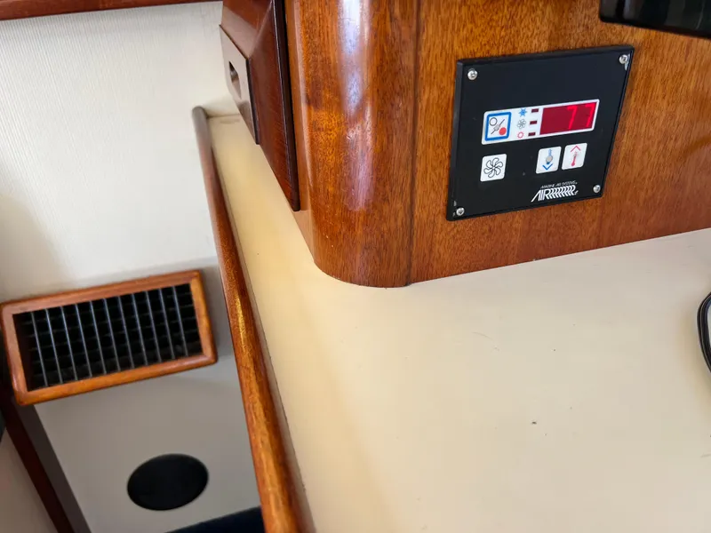 Slide: The Image of Interior of 2001 Camano 31 Troll boat, featuring control panel and wood finish. - 36