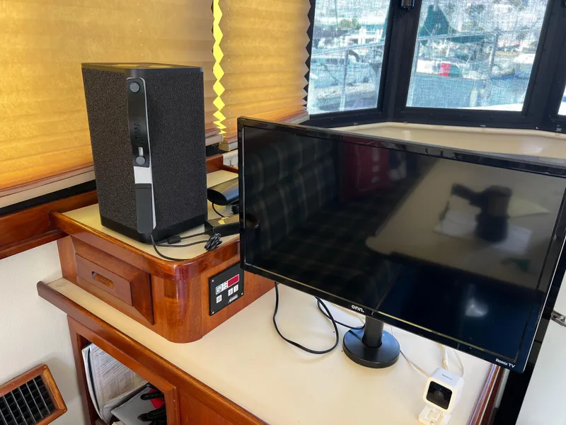 Slide: The Image of Interior of 2001 Camano 31 Troll with monitor and speaker setup on wooden surface. - 37