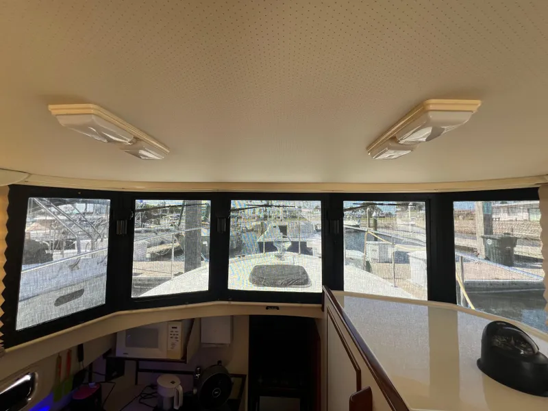 Slide: The Image of Interior view of 2001 Camano 31 Troll boat with large windows and ceiling lights. - 38