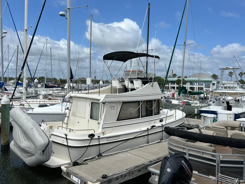 Slide: The Image of 2001 Camano 31 Troll boat docked at a marina under a clear blue sky. - 4