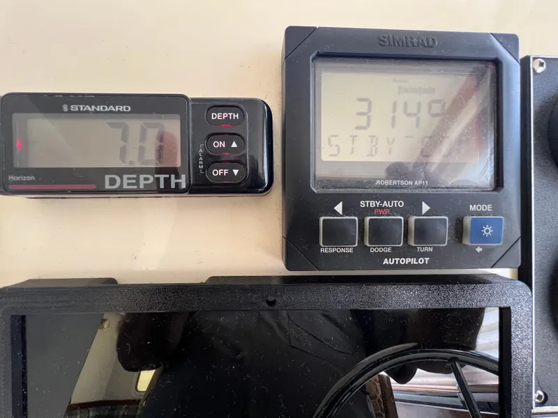 Slide: The Image of Boat control panel with depth gauge and autopilot display on a 2001 Camano 31 Troll. - 46