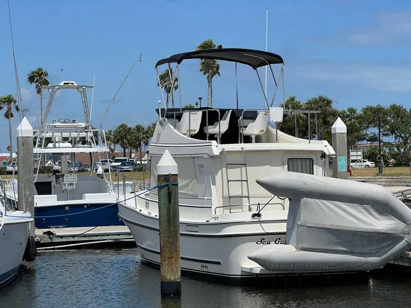 Slide: The Image of 2001 Camano 31 Troll boat docked at marina with clear blue sky. - 5