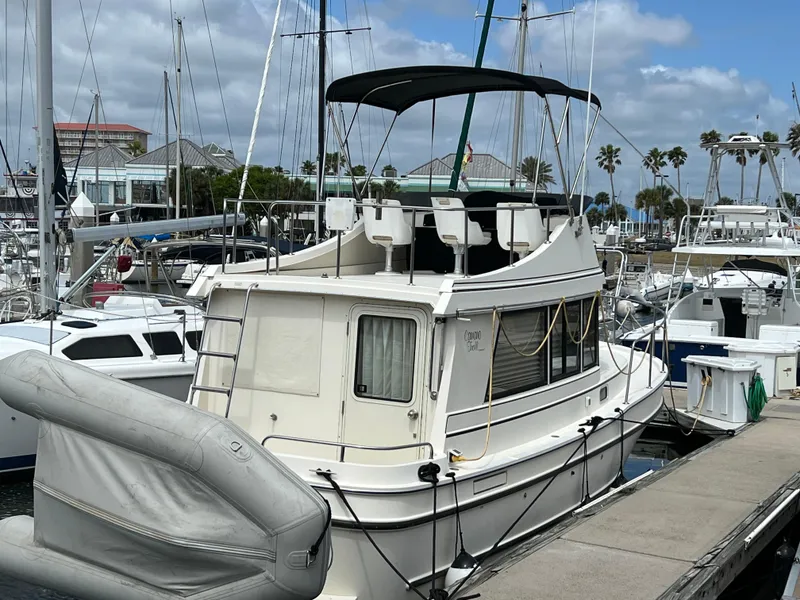 Slide: The Image of 2001 Camano 31 Troll boat docked at marina under cloudy sky. - 6