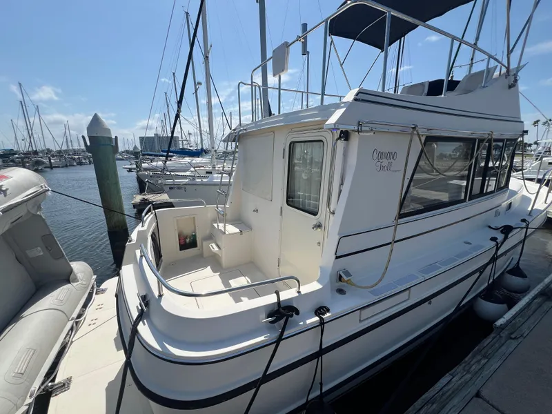 Slide: The Image of 2001 Camano 31 Troll boat docked at marina under clear blue sky. - 7