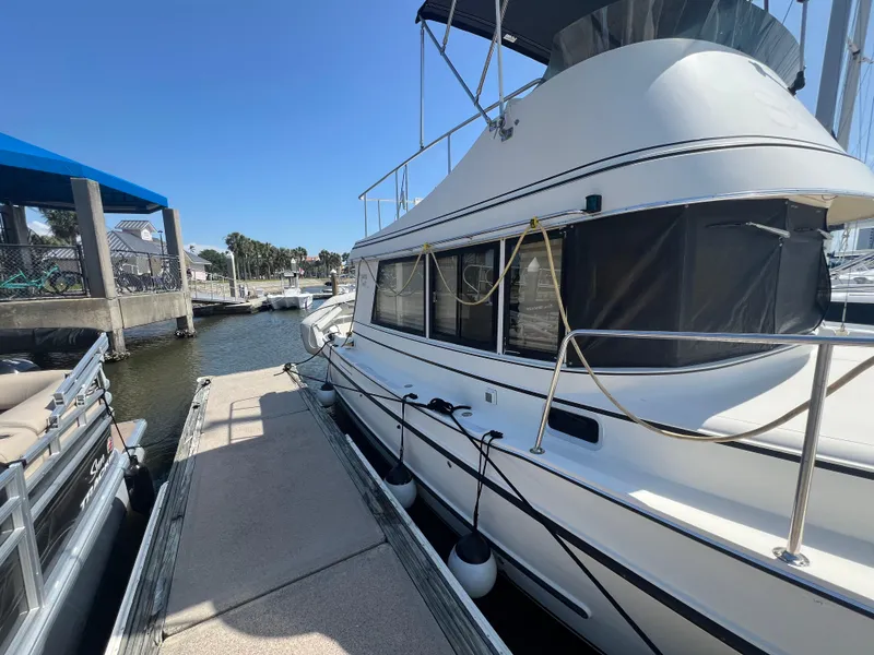 Slide: The Image of 2001 Camano 31 Troll boat docked at marina under clear blue sky. - 8