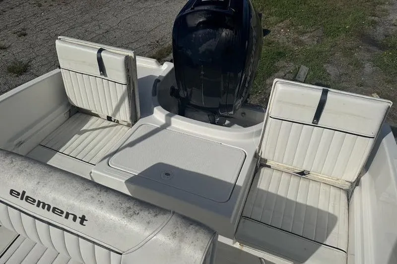 Slide: The Image of 2017 Bayliner Element F18 boat interior with seating and motor. - 10
