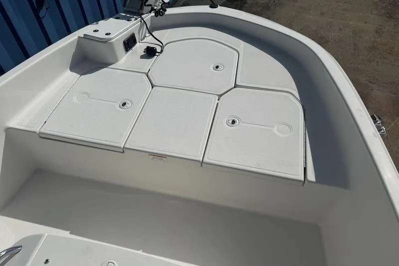 Slide: The Image of 2017 Bayliner Element F18 boat deck with storage compartments and control panel. - 11