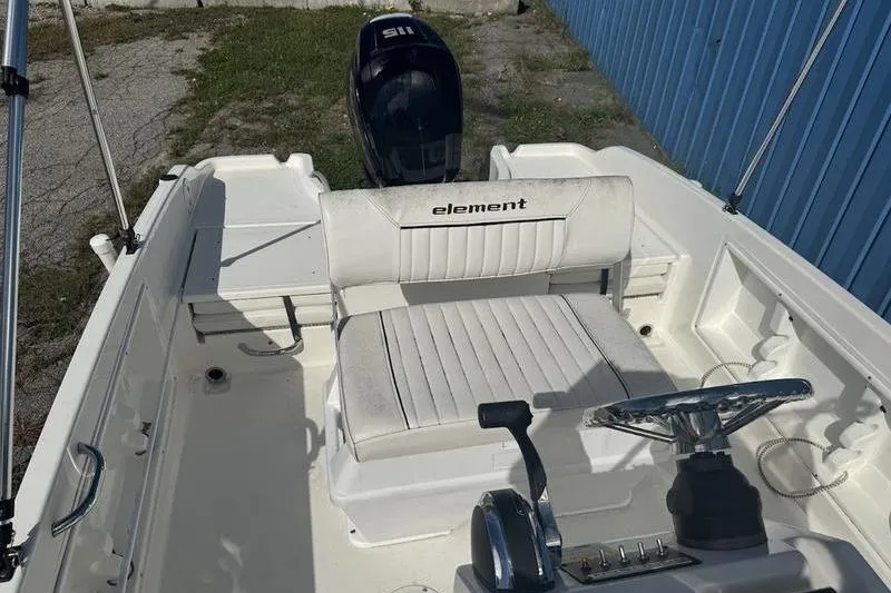 Slide: The Image of 2017 Bayliner Element F18 boat interior with steering wheel and seating. - 13