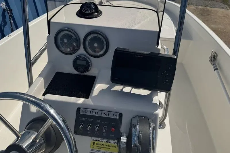 Slide: The Image of 2017 Bayliner Element F18 boat dashboard with gauges and controls. - 6