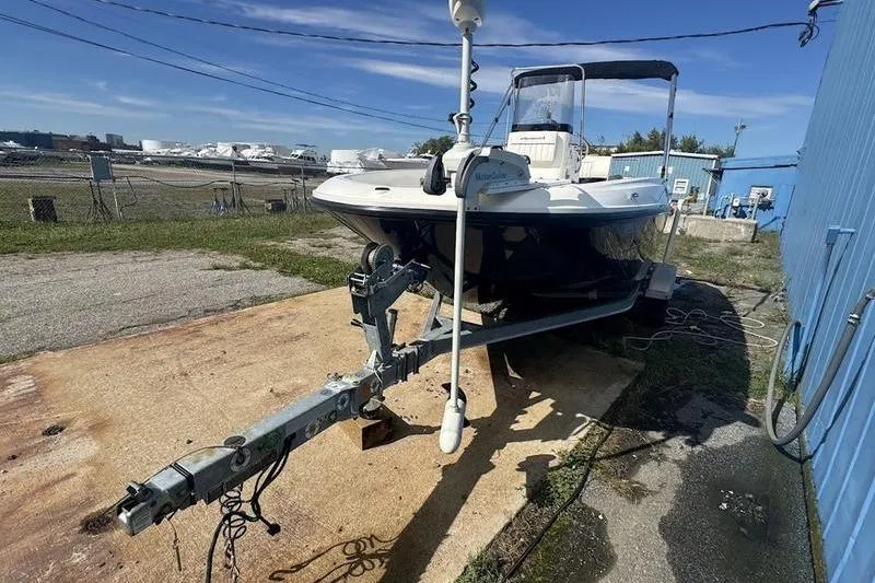 Slide: The Image of 2017 Bayliner Element F18 boat on trailer near blue building. - 9