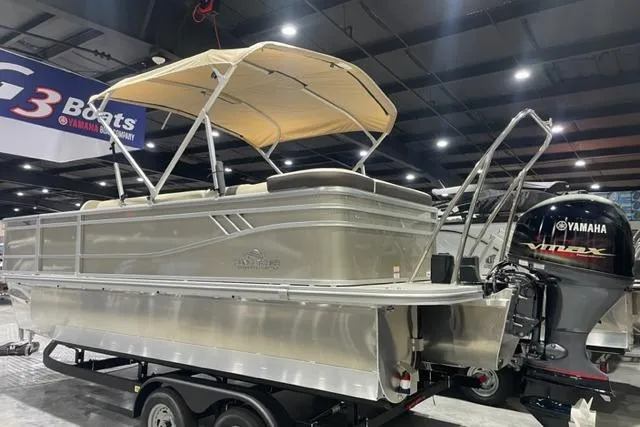 Slide: The Image of 2025 SunCatcher Select 320FC pontoon boat with Yamaha engine on display indoors. - 1
