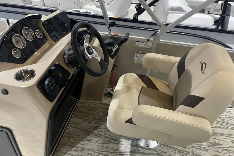 Slide: The Image of Captain's seat and dashboard of 2025 SunCatcher Select 320FC boat. - 14
