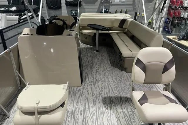 Slide: The Image of 2025 SunCatcher Select 320FC boat interior with beige seating and modern design. - 4