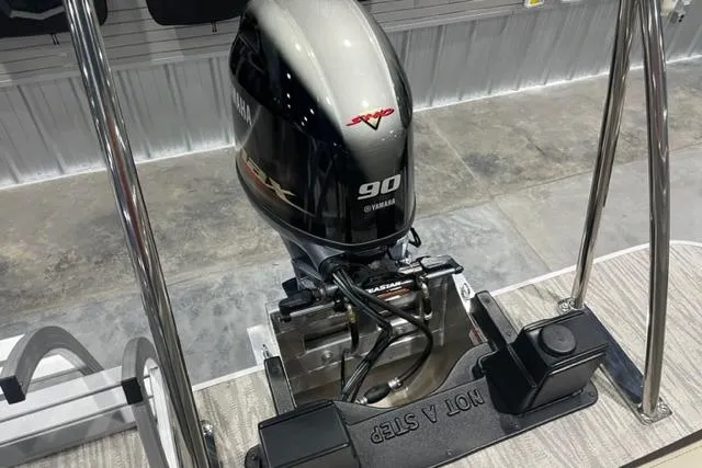 Slide: The Image of 2025 SunCatcher Select 320FC with Yamaha 90 outboard motor, displayed indoors. - 7