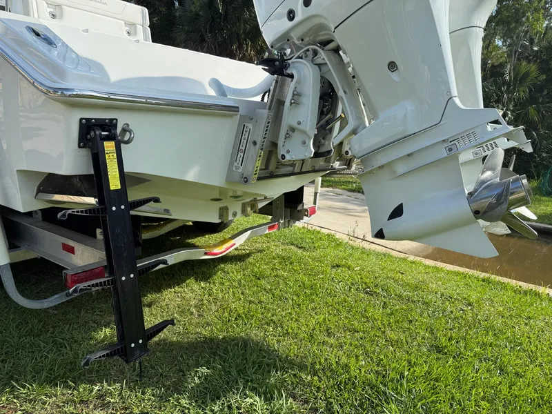 Slide: The Image of 2023 SeaHunter 28 Floridian boat with outboard motor on grassy area. - 17
