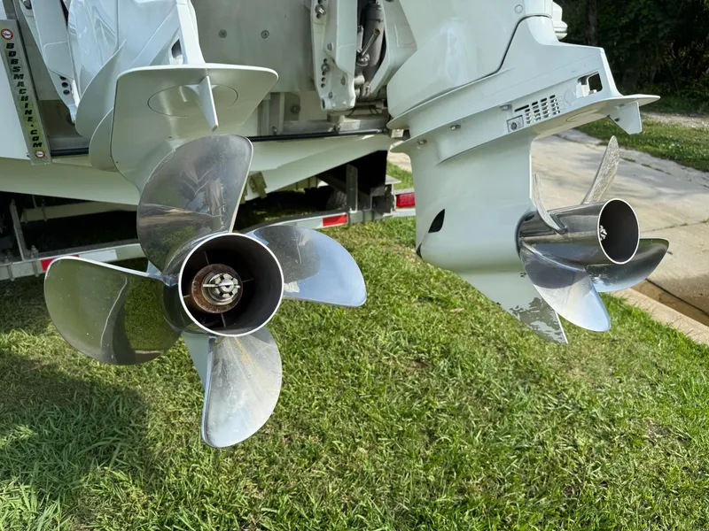 Slide: The Image of Propellers of 2023 SeaHunter 28 Floridian boat on grass, showcasing dual engines. - 18