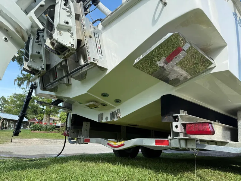 Slide: The Image of 2023 SeaHunter 28 Floridian boat on trailer, showing rear view and engine mount details. - 20