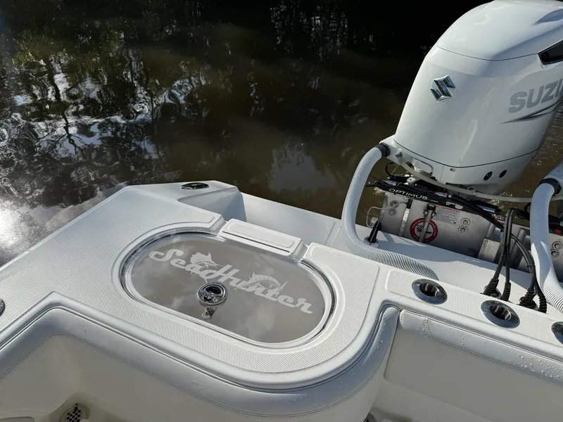 Slide: The Image of 2023 SeaHunter 28 Floridian boat with Suzuki engine, docked by the water. - 23