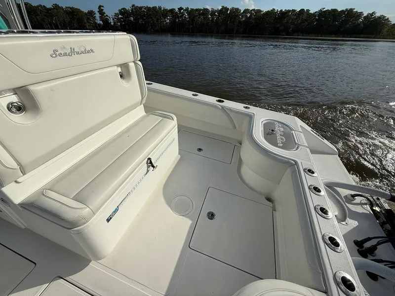 Slide: The Image of 2023 SeaHunter 28 Floridian boat interior with seating, rod holders, and water view. - 26