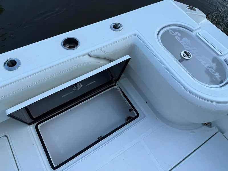 Slide: The Image of 2023 SeaHunter 28 Floridian boat deck with storage compartments and rod holders. - 27
