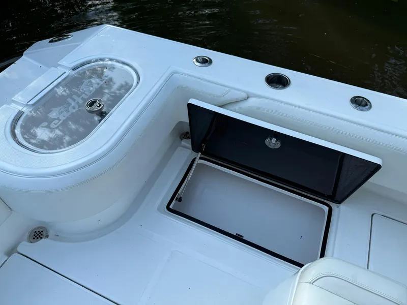 Slide: The Image of 2023 SeaHunter 28 Floridian boat deck with storage compartment and livewell. - 28