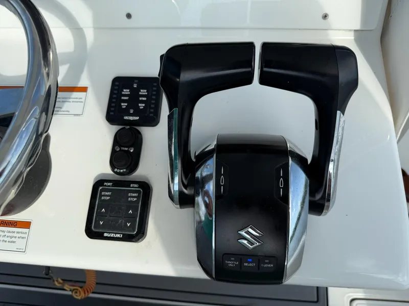 Slide: The Image of 2023 SeaHunter 28 Floridian boat controls with Suzuki throttle and control panel. - 44