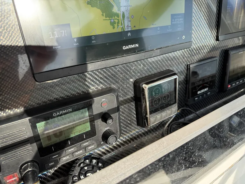 Slide: The Image of Dashboard of 2023 SeaHunter 28 Floridian with Garmin navigation and control systems. - 48