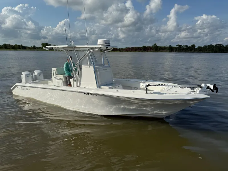 Slide: The Image of 2023 SeaHunter 28 Floridian boat on calm water under a partly cloudy sky. - 7
