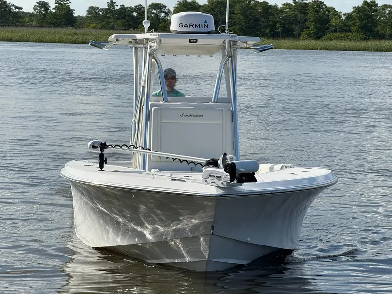 Slide: The Image of 2023 SeaHunter 28 Floridian boat on calm water, featuring Garmin equipment. - 8