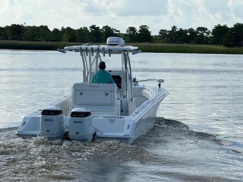 Slide: The Image of 2023 SeaHunter 28 Floridian boat cruising on a calm river with twin engines. - 9