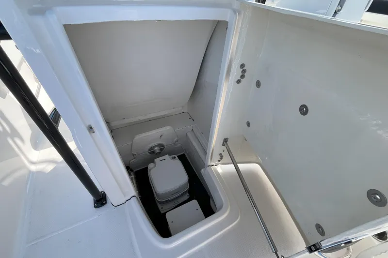 Slide: The Image of 2026 Robalo R202 Explorer boat interior with compact marine toilet. - 10