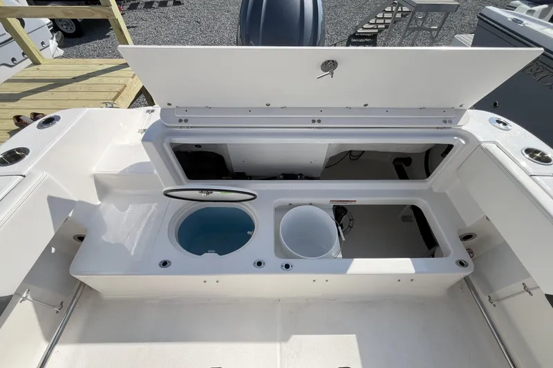 Slide: The Image of 2026 Robalo R202 Explorer boat storage compartments and livewell, open view. - 4